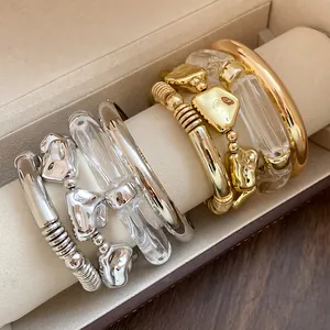 Macro view showing geometric metal and clear acrylic bracelet four-piece set details