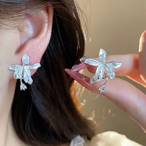 Exquisite 18k gold plated flower stud earrings featuring sparkling zircon accents.