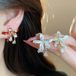 Detailed close-up of 18k gold plated flower stud earrings with sparkling cubic zircons