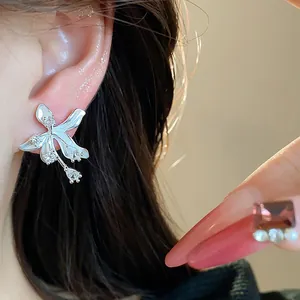 Close-up of elegant 18k gold plated flower stud earrings featuring sparkling cubic zirconia