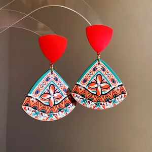 Detailed view of ethnic print acrylic drop earrings with geometric triangle patterns.