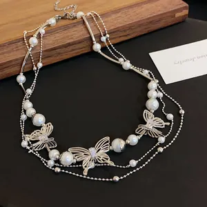 Macro detail of elegant silver-tone butterfly necklace adorned with pearls and crystals