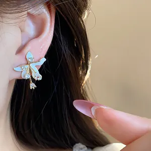 Detailed view of an elegant white flower stud earring with gold plating and zircons