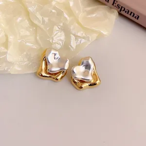 Minimalist two-tone heart-shaped metal stud earrings with twisted design for women