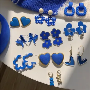 Collection of trendy Klein blue earrings in diverse shapes like hearts and flowers