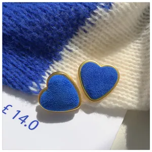 Macro view of the soft velvet texture on these Klein Blue heart stud earrings