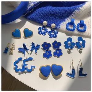 Detailed collection of Klein blue fashion earrings with various artistic designs.