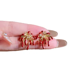 Elegant 18k gold plated firework stud earrings with red zircon accents on silver needles
