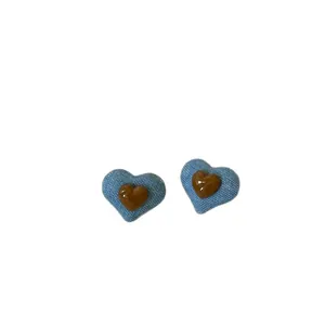 Elegant heart stud earrings featuring blue denim texture and glossy brown resin detail