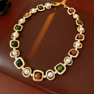 Vintage court style necklace featuring pearls and multi-colored beads in gold frames.