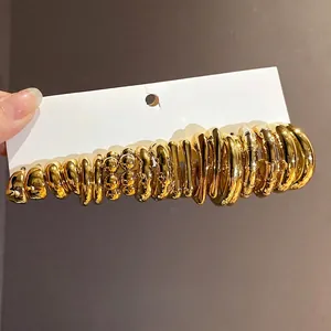 Chic collection of gold C-shaped minimalist hoop earrings with high-polish finish