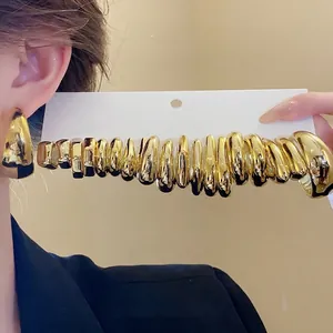 Elegant set of minimalist gold-tone C-shaped hoop earrings in various sizes for women