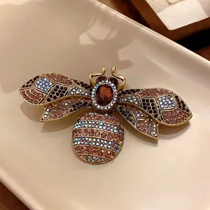 Luxurious vintage palace style bee brooch encrusted with colorful rhinestones for women.