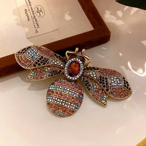 Vintage royal style bee brooch with colorful rhinestones and amber crystal center