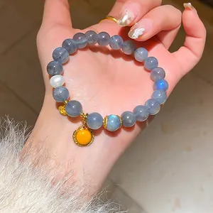 Close-up detail of new Chinese style moonstone beaded bracelet with pearl and yellow pendant