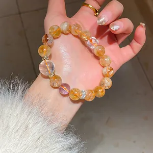 Close-up detail of a New Chinese style beaded bracelet with clear and amber stones