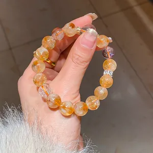 Close-up of multi-gemstone beaded bracelet with golden rutilated quartz details