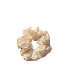 Elegant cream lace scrunchie with intricate floral embroidery for women hair styling