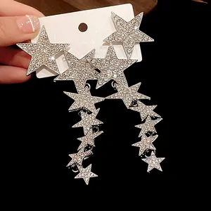 Close-up of sparkling rhinestone star tassel earrings with elegant long drop design
