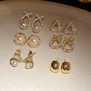 Detailed view of vintage French style earring set featuring pearls and rhinestones