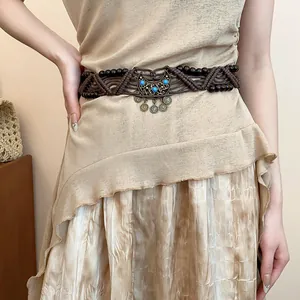 Close-up of Bohemian handmade braided rope belt with wooden beads and turquoise accents