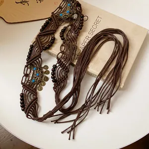Detailed view of bohemian ethnic woven waist chain featuring wooden beads and metal moon charms.