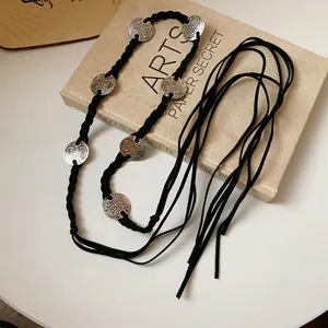 Close-up of Bohemian braided waist chain with intricate silver-toned metallic discs.