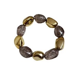Elegante bracciale elastico vintage in acrilico con perline dorate e grigie glitterate