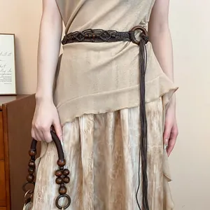Handmade bohemian woven belt with dark brown wooden beads on model
