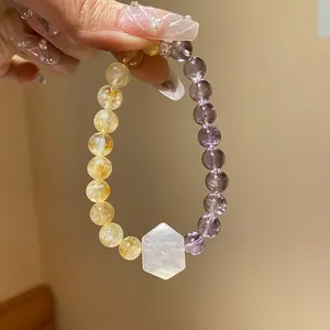 Macro view of elegant amethyst and citrine beaded bracelet with hexagonal quartz stone