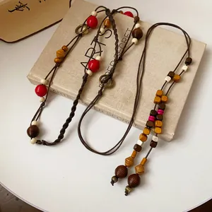 Detailed texture of bohemian braided hemp rope waist chain with colorful wooden beads
