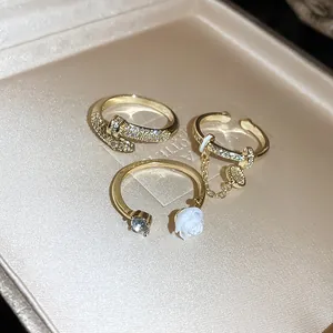 Detailed view of luxury gold-plated rings with zircon-encrusted snake and flower charms