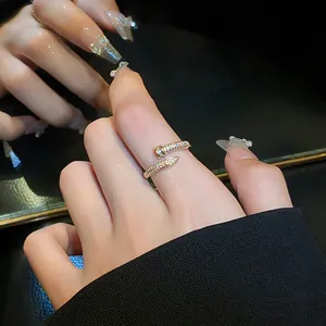 Exquisite zircon-encrusted open snake nail ring shown on a finger for elegant jewelry detail