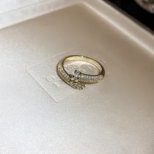 Macro detail of a luxury gold serpent wrap ring encrusted with sparkling zircon stones