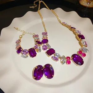Elegant purple gemstone jewelry set with necklace, bracelet, and silver pin earrings.