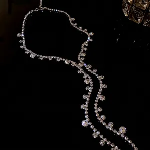 Elegant sparkly rhinestone geometric fringe necklace on a premium dark reflective background