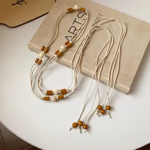 Detailed macro view of Bohemian multi-layer hemp rope waist chain with wooden beads
