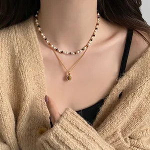 Vintage tiger eye stone gold layered necklace for women shown on cozy beige sweater
