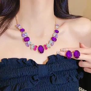 Detailed close-up shot of purple oval crystal stud earrings worn by an Asian model