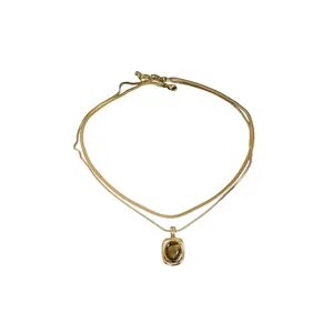 Vintage double-layered gold tone necklace with a rectangular tiger eye stone pendant