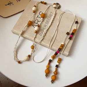 Detailed view of Bohemian braided hemp rope waist chain with colorful wooden beads.
