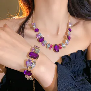 Close-up detail of elegant purple rhinestone necklace and matching bracelet on a model