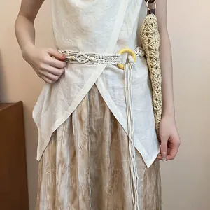 Detailed close-up of a Bohemian hand-woven macramé belt with wooden beads and ring