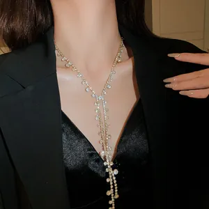 Close-up of elegant Y-shaped tassel necklace with shimmering rhinestones on black