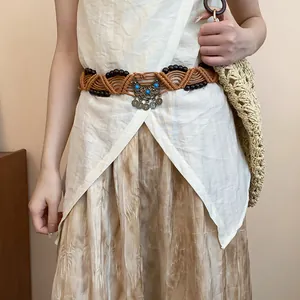 Close-up of bohemian woven hemp rope belt with wooden beads and turquoise accents