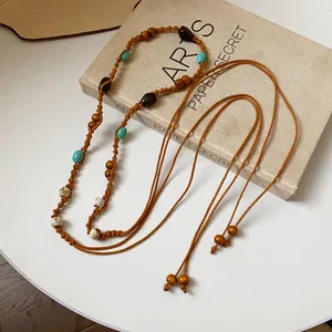 Detail view of a bohemian braided hemp rope waist chain featuring colorful wood beads