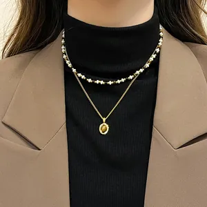 Close-up of vintage layered tiger eye pendant necklace with multicolored beaded choker