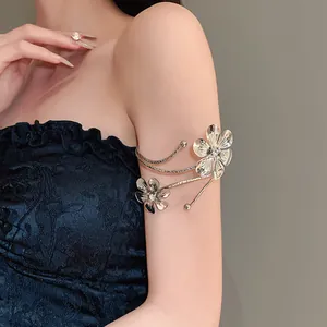 Dettaglio del bracciale da braccio a fiori d'argento con strass sul braccio.