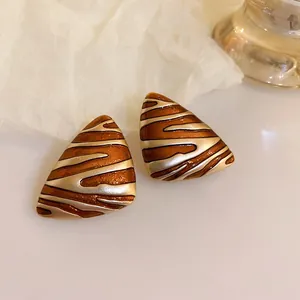 Detail view of vintage Maillard style brown and silver striped triangular earrings