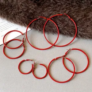 Set of simple red round hoop earrings in various sizes with steel pins for women